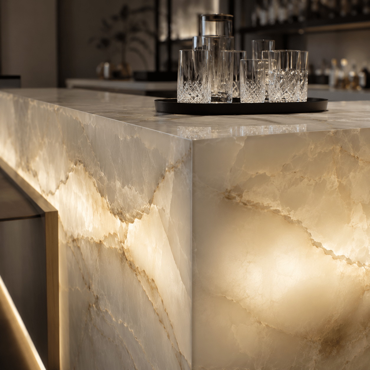 Custom-fabricated monolithic commercial bar counter featuring seamless mitered joints, executed via our luxury onyx stone project supply.
