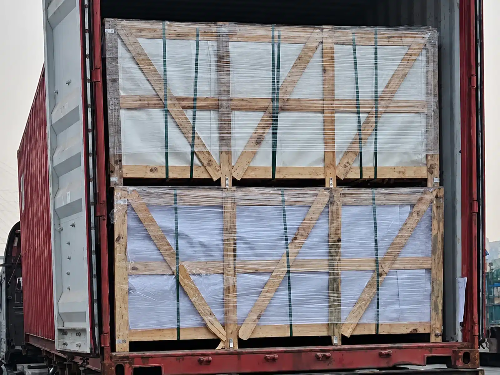 Crated building materials arranged inside a shipping container