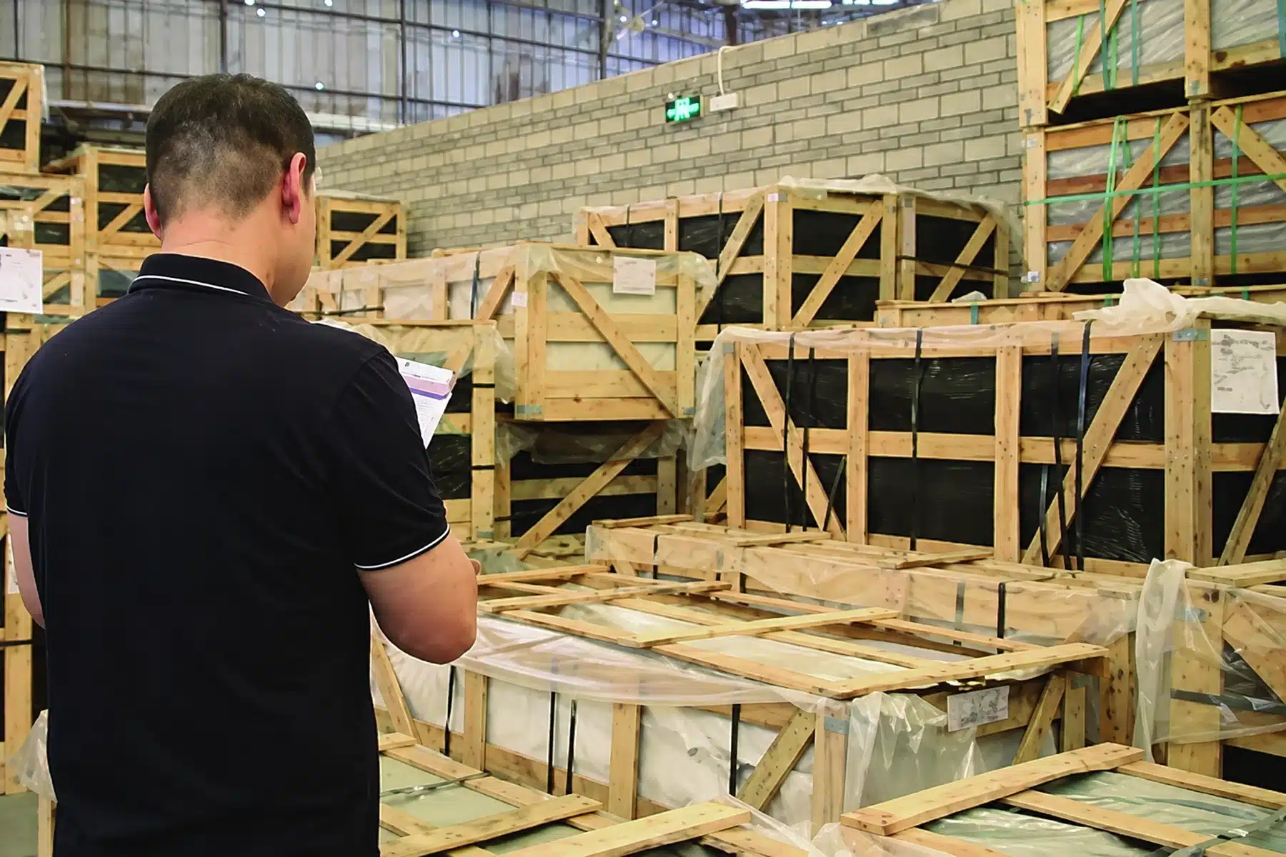 Project staff reviewing crated materials before container load planning