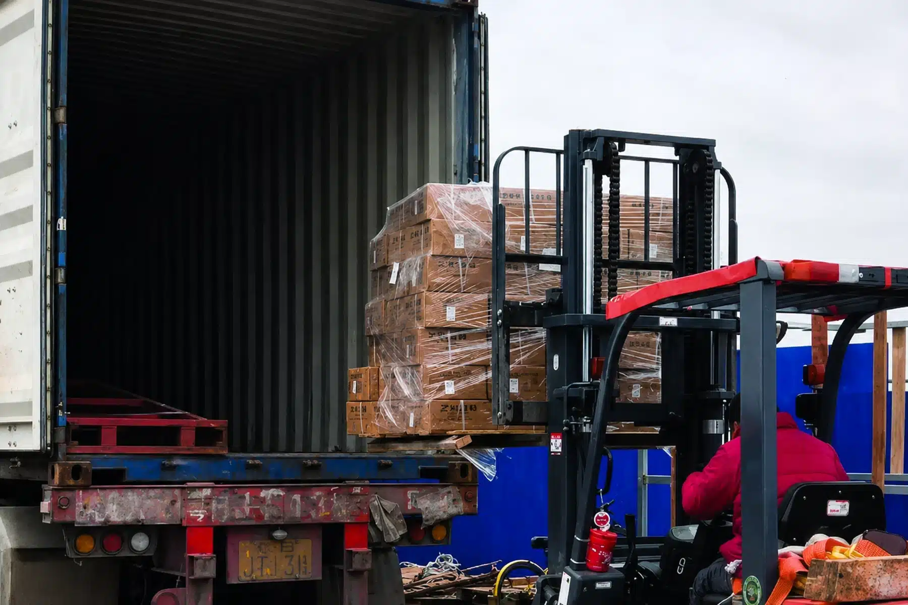 Palletized building materials loaded into a truck at a warehouse